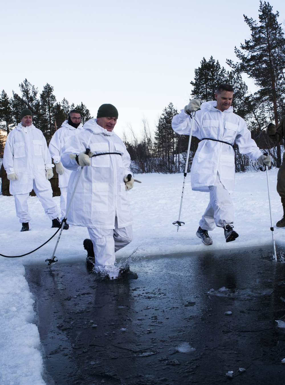 Norwegian and U.S. generals and sergeants major conduct an ice-breaking drill