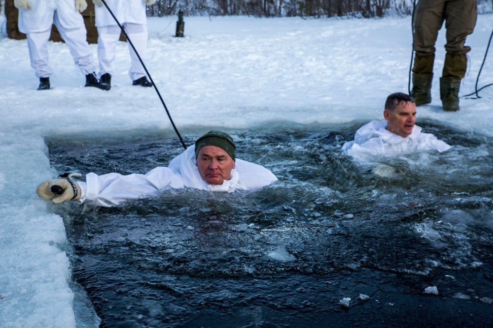 Norwegian and U.S. generals and sergeants major conduct an ice-breaking drill