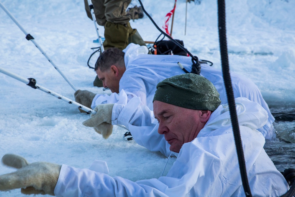 Norwegian and U.S. generals and sergeants major conduct an ice-breaking drill