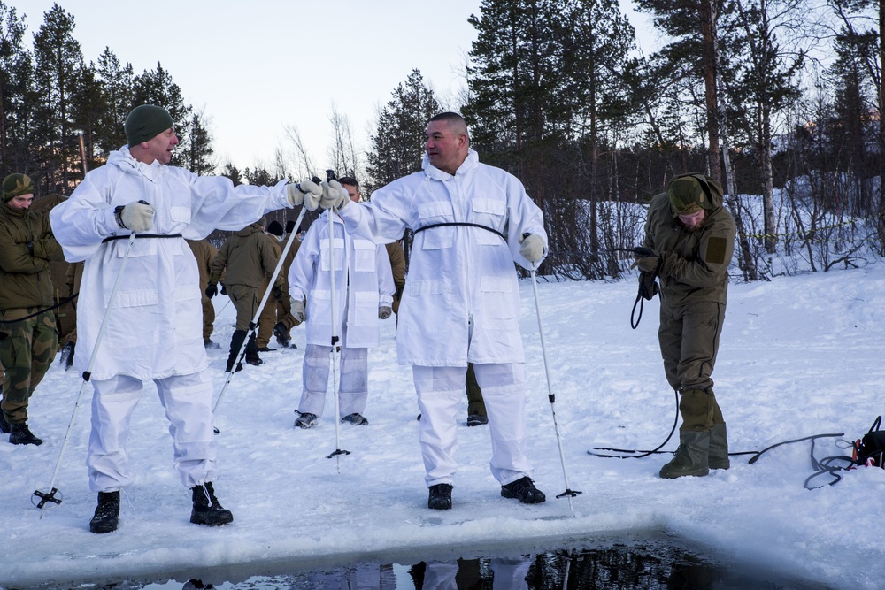 Norwegian and U.S. generals and sergeants major conduct an ice-breaking drill