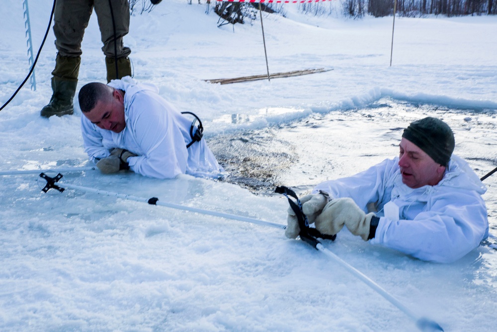 Norwegian and U.S. generals and sergeants major conduct an ice-breaking drill