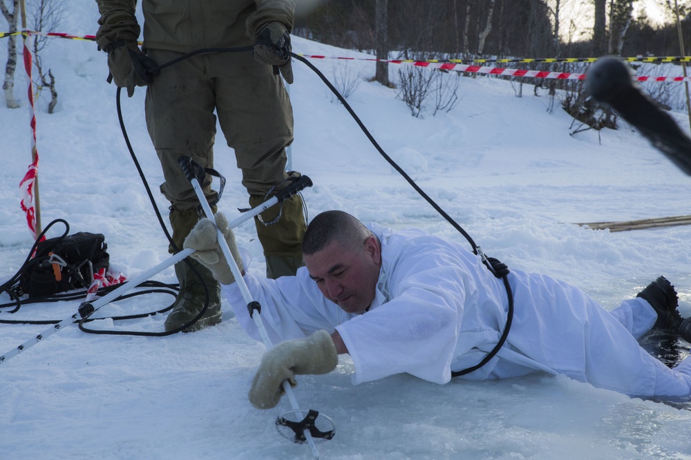 Norwegian and U.S. generals and sergeants major conduct an ice-breaking drill