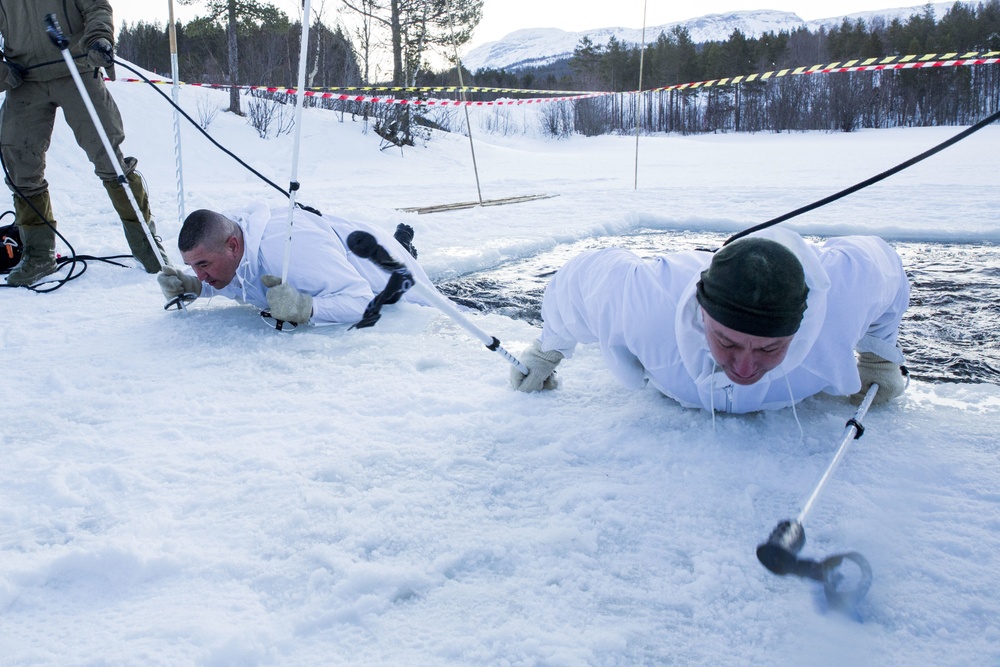 Norwegian and U.S. generals and sergeants major conduct an ice-breaking drill