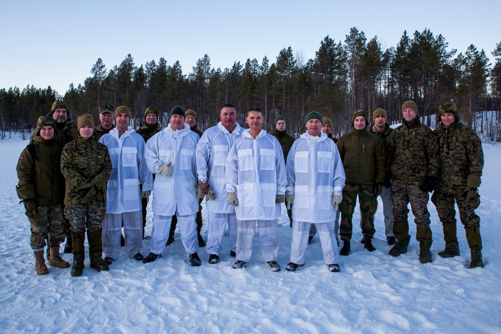 Norwegian and U.S. generals and sergeants major conduct an ice-breaking drill