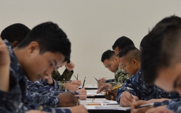 Reserve Sailors assigned to Navy Operational Support Center (NOSC) Los Angeles take the January E-4 to E-7 advancement exams in the drill hall at NOSC Los Angeles