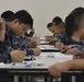 Reserve Sailors assigned to Navy Operational Support Center (NOSC) Los Angeles take the January E-4 to E-7 advancement exams in the drill hall at NOSC Los Angeles