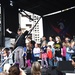 Gary Sinise and the Lt. Dan Band perform on stage with children at Naval Medical Center San Diego