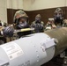 477th Maintenance Squadron Airmen practice bomb building in a simulated toxic environment