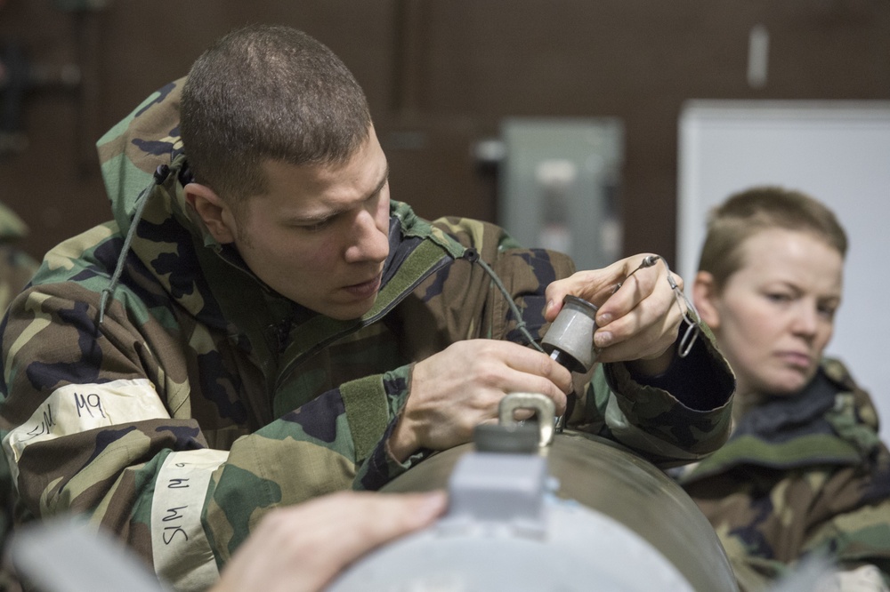 477th Maintenance Squadron Airmen practice bomb building in a simulated toxic environment