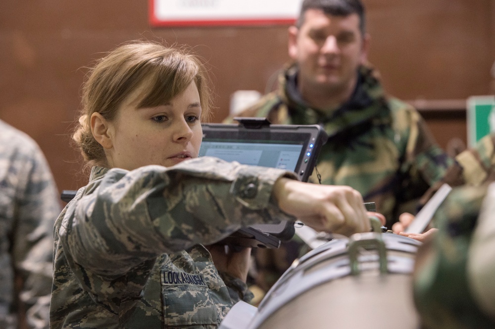 477th Maintenance Squadron Airmen practice bomb building in a simulated toxic environment