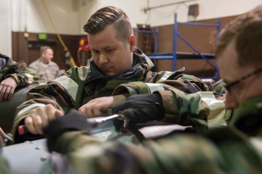 477th Maintenance Squadron Airmen practice bomb building in a simulated toxic environment