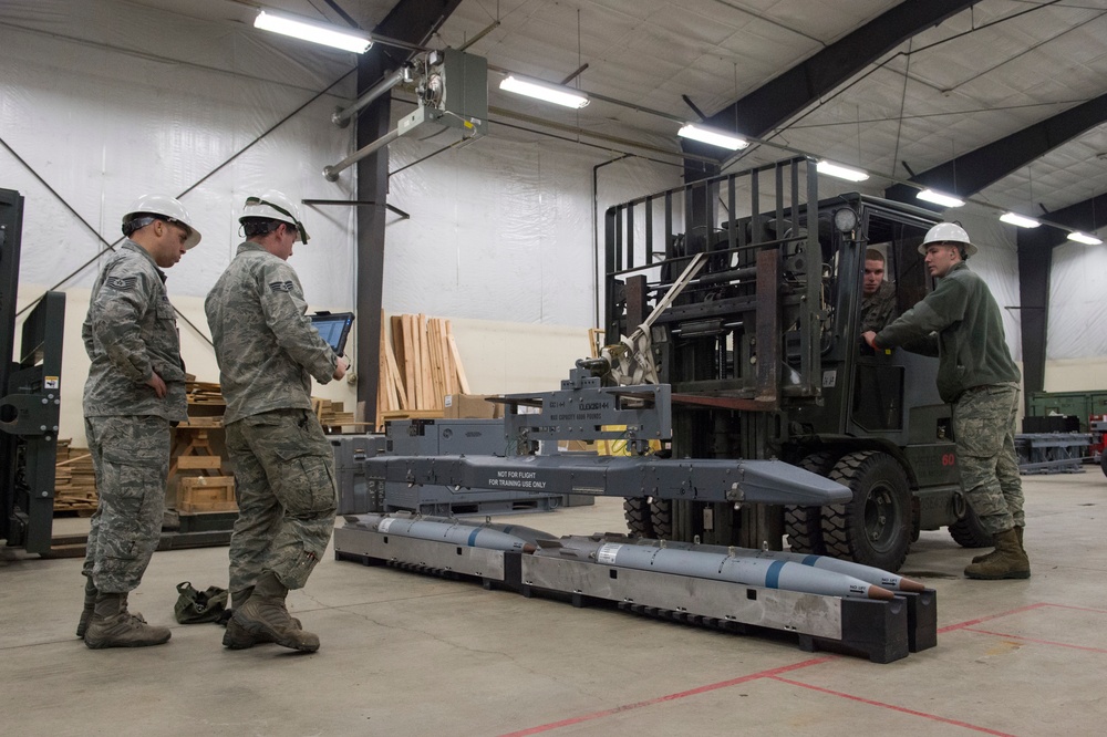 3rd Munitions Squadron Airmen practice handling small diameter bombs