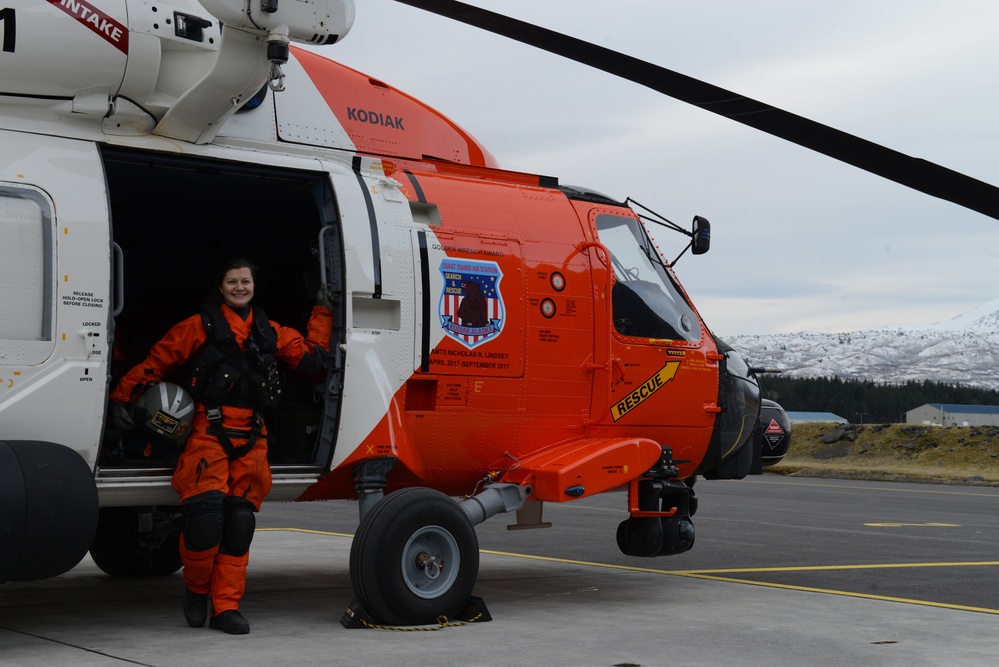 AMT2 Best poses next to an MH-60 Jayhawk helicopter