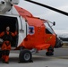 AMT2 Best poses next to an MH-60 Jayhawk helicopter