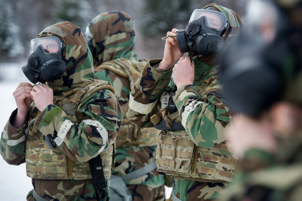 Explosives Ordinance Disposal Airmen conduct live-fire range in simulated chemical environment