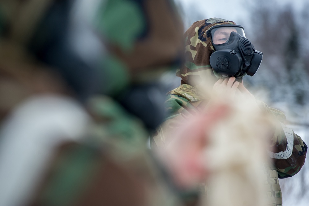 Explosives Ordinance Disposal Airmen conduct live-fire range in simulated chemical environment