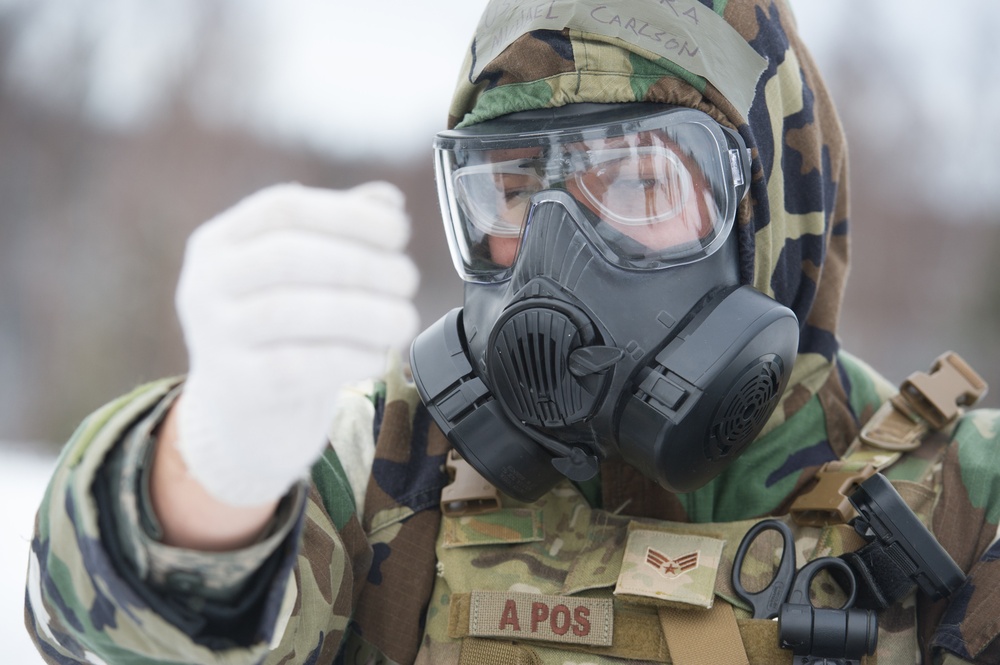 Explosives Ordinance Disposal Airmen conduct live-fire range in simulated chemical environment