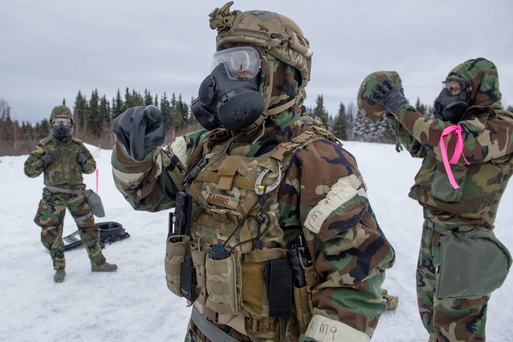 Explosives Ordinance Disposal Airmen conduct live-fire range in simulated chemical environment