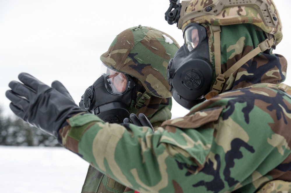 Explosives Ordinance Disposal Airmen conduct live-fire range in simulated chemical environment