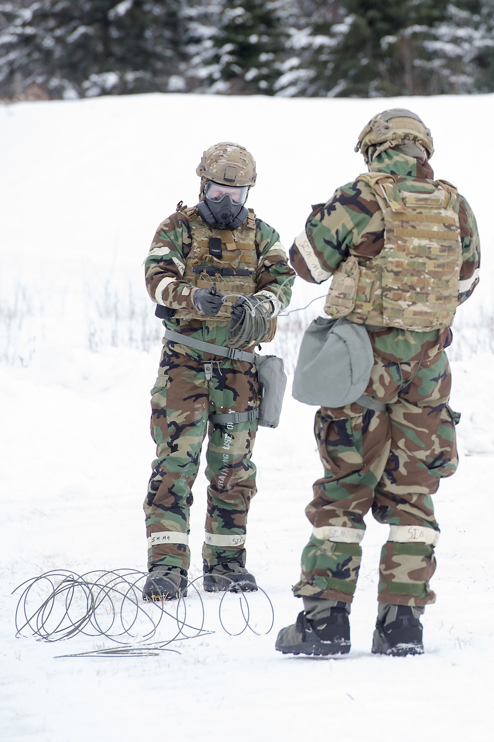 Explosives Ordinance Disposal Airmen conduct live-fire range in simulated chemical environment