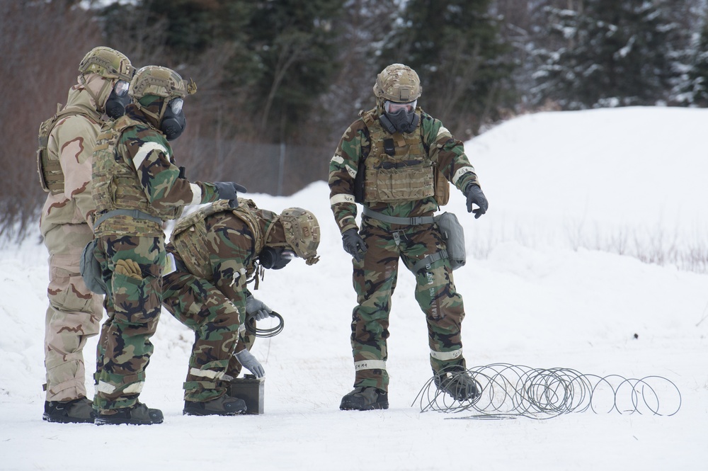 Explosives Ordinance Disposal Airmen conduct live-fire range in simulated chemical environment