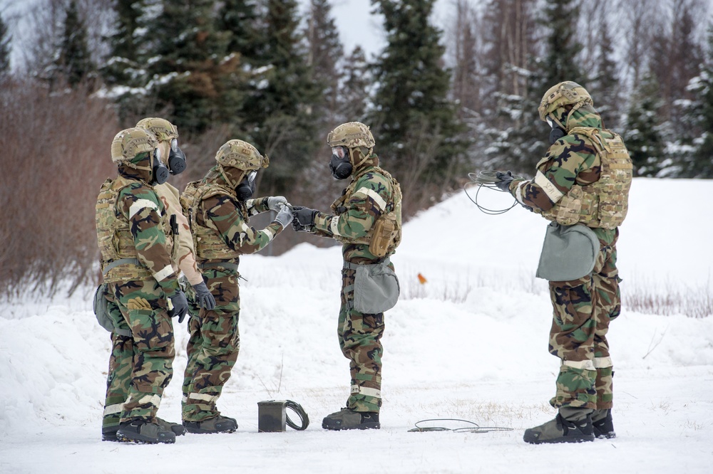 Explosives Ordinance Disposal Airmen conduct live-fire range in simulated chemical environment