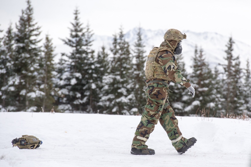 Explosives Ordinance Disposal Airmen conduct live-fire range in simulated chemical environment