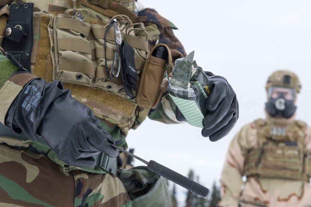 Explosives Ordinance Disposal Airmen conduct live-fire range in simulated chemical environment