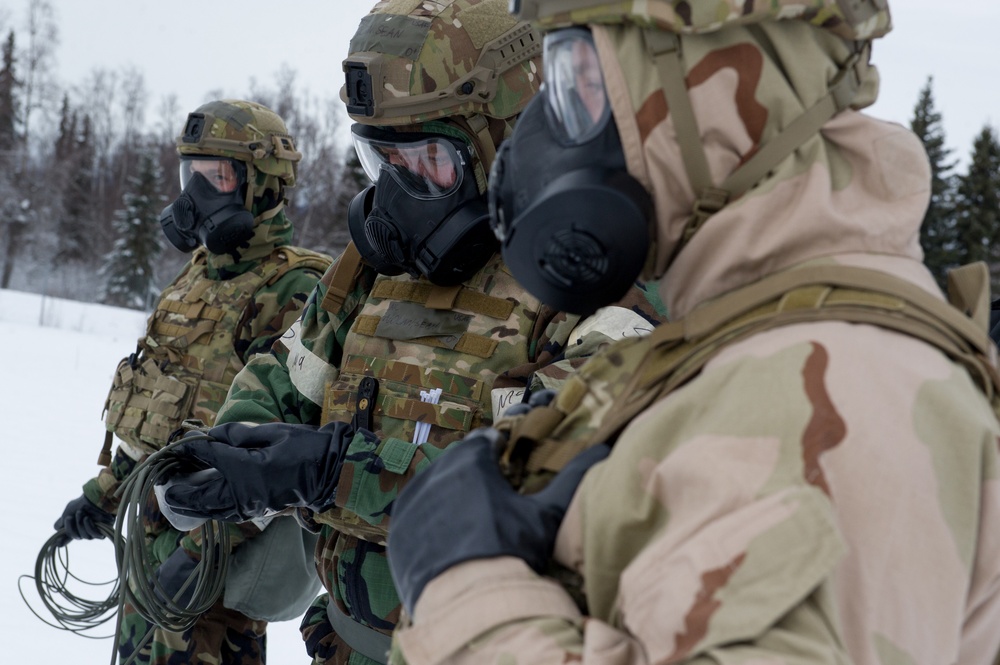 Explosives Ordinance Disposal Airmen conduct live-fire range in simulated chemical environment