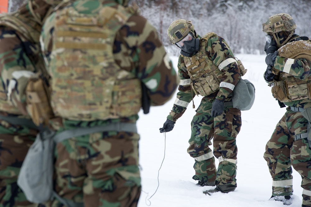 Explosives Ordinance Disposal Airmen conduct live-fire range in simulated chemical environment