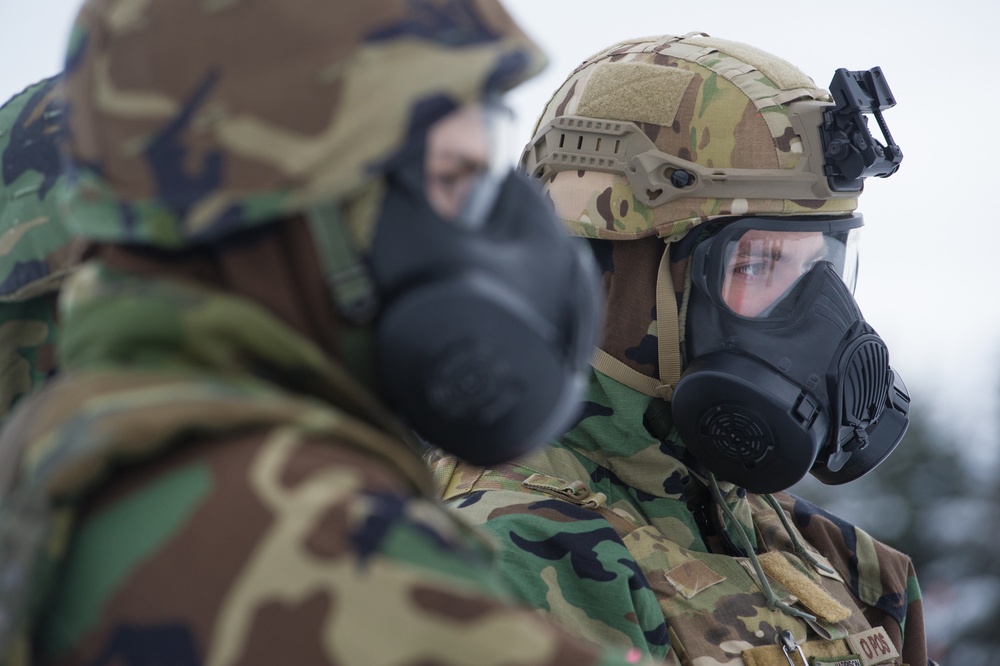 Explosives Ordinance Disposal Airmen conduct live-fire range in simulated chemical environment