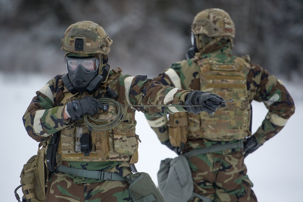 Explosives Ordinance Disposal Airmen conduct live-fire range in simulated chemical environment