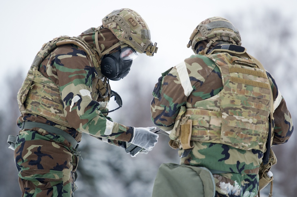 Explosives Ordinance Disposal Airmen conduct live-fire range in simulated chemical environment