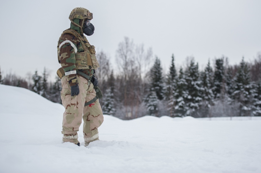 Explosives Ordinance Disposal Airmen conduct live-fire range in simulated chemical environment