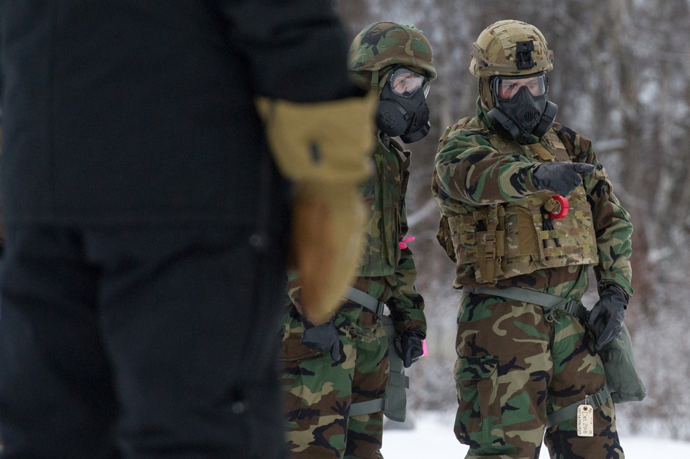 Explosives Ordinance Disposal Airmen conduct live-fire range in simulated chemical environment