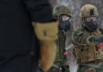 Explosives Ordinance Disposal Airmen conduct live-fire range in simulated chemical environment