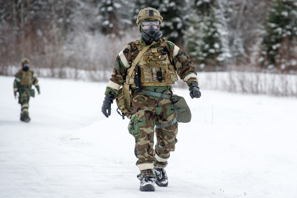 Explosives Ordinance Disposal Airmen conduct live-fire range in simulated chemical environment