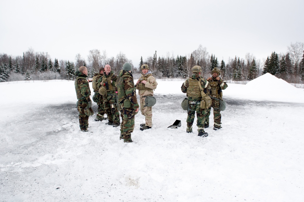 Explosives Ordinance Disposal Airmen conduct live-fire range in simulated chemical environment