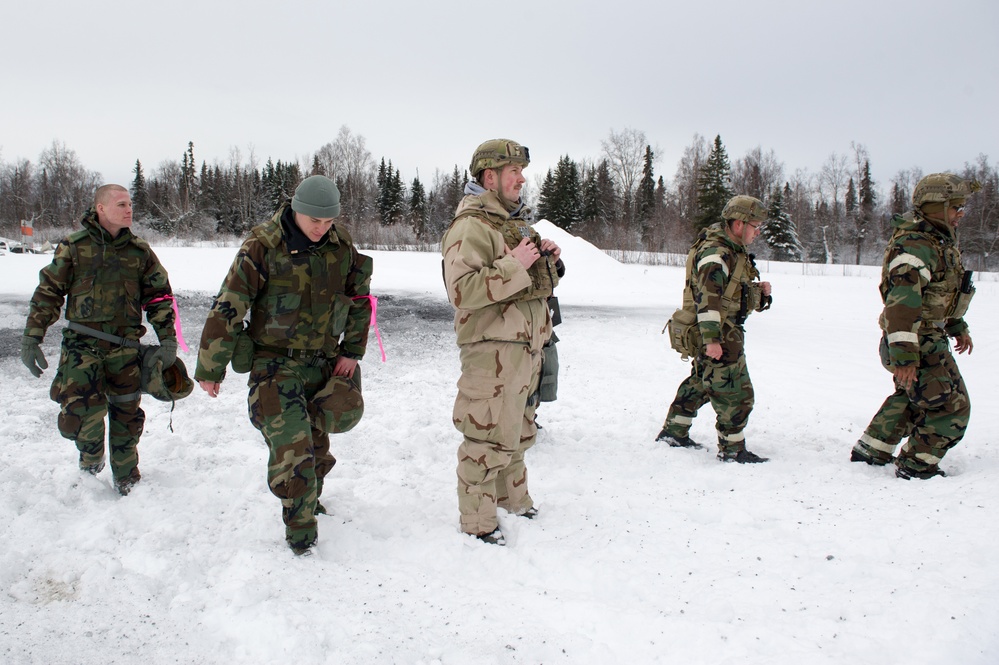 Explosives Ordinance Disposal Airmen conduct live-fire range in simulated chemical environment