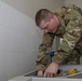 Soldier Cleans Equipment Sterilization Unit