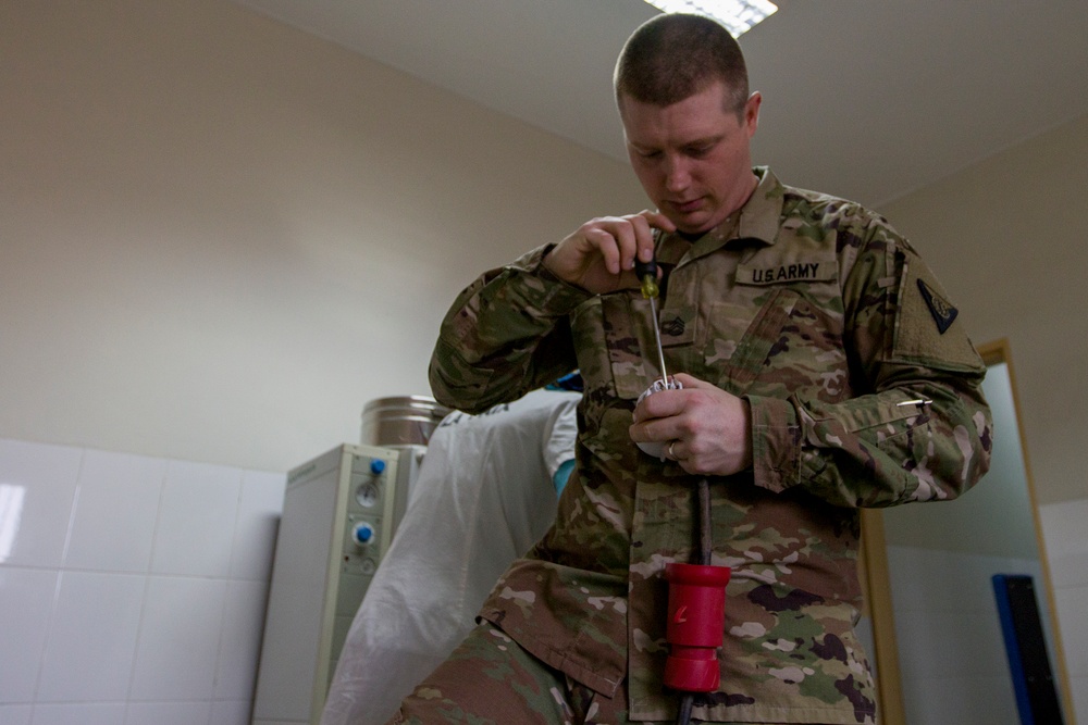 Soldier Affixes Plug to Power Cord