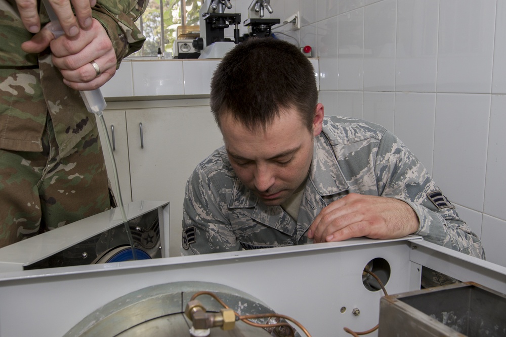 Airman Flushes Equipment Sterilization Unit Hoses