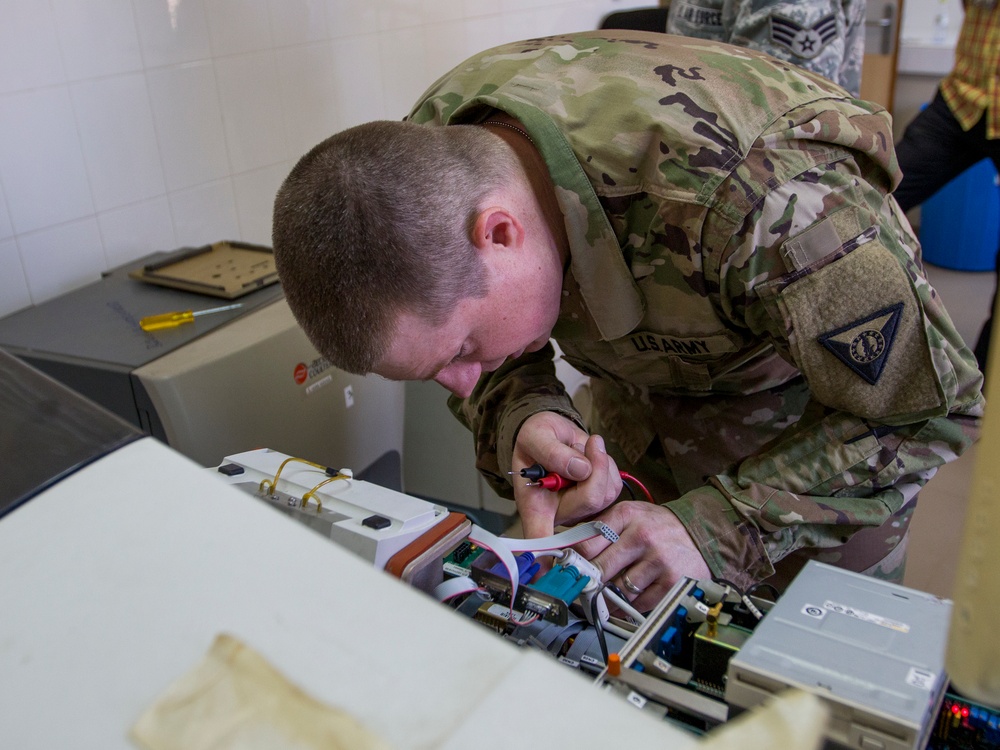 Soldier Tests Chemsitry Lab Analyzer Connections with Multimeter
