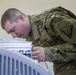 Soldier Tests Chemsitry Lab Analyzer Connections with Multimeter