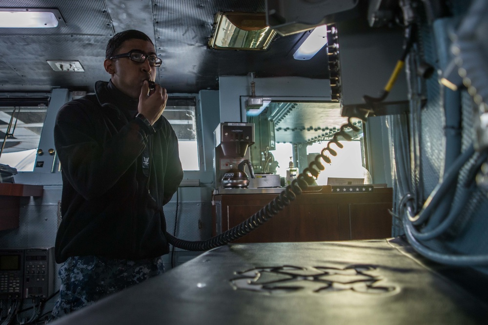Sailor signals end of colors aboard USS John C. Stennis