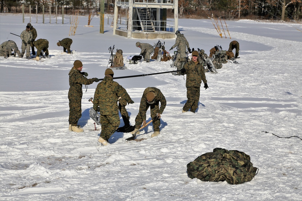 Cold-Weather Operations Course Class 18-04 students build Arctic tents during training at Fort McCoy