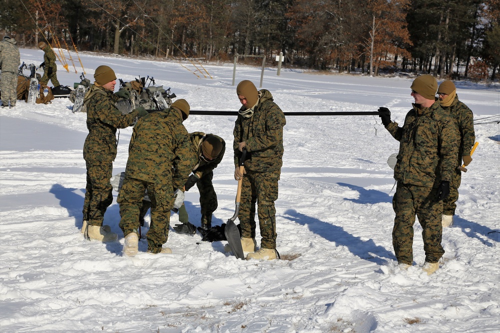 Cold-Weather Operations Course Class 18-04 students build Arctic tents during training at Fort McCoy