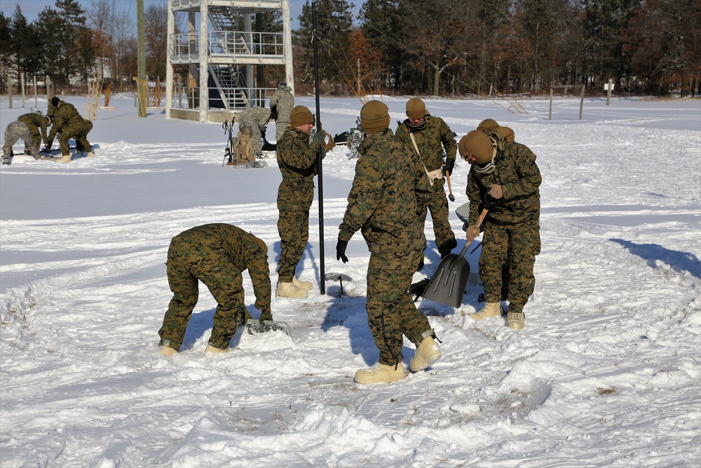 Cold-Weather Operations Course Class 18-04 students build Arctic tents during training at Fort McCoy