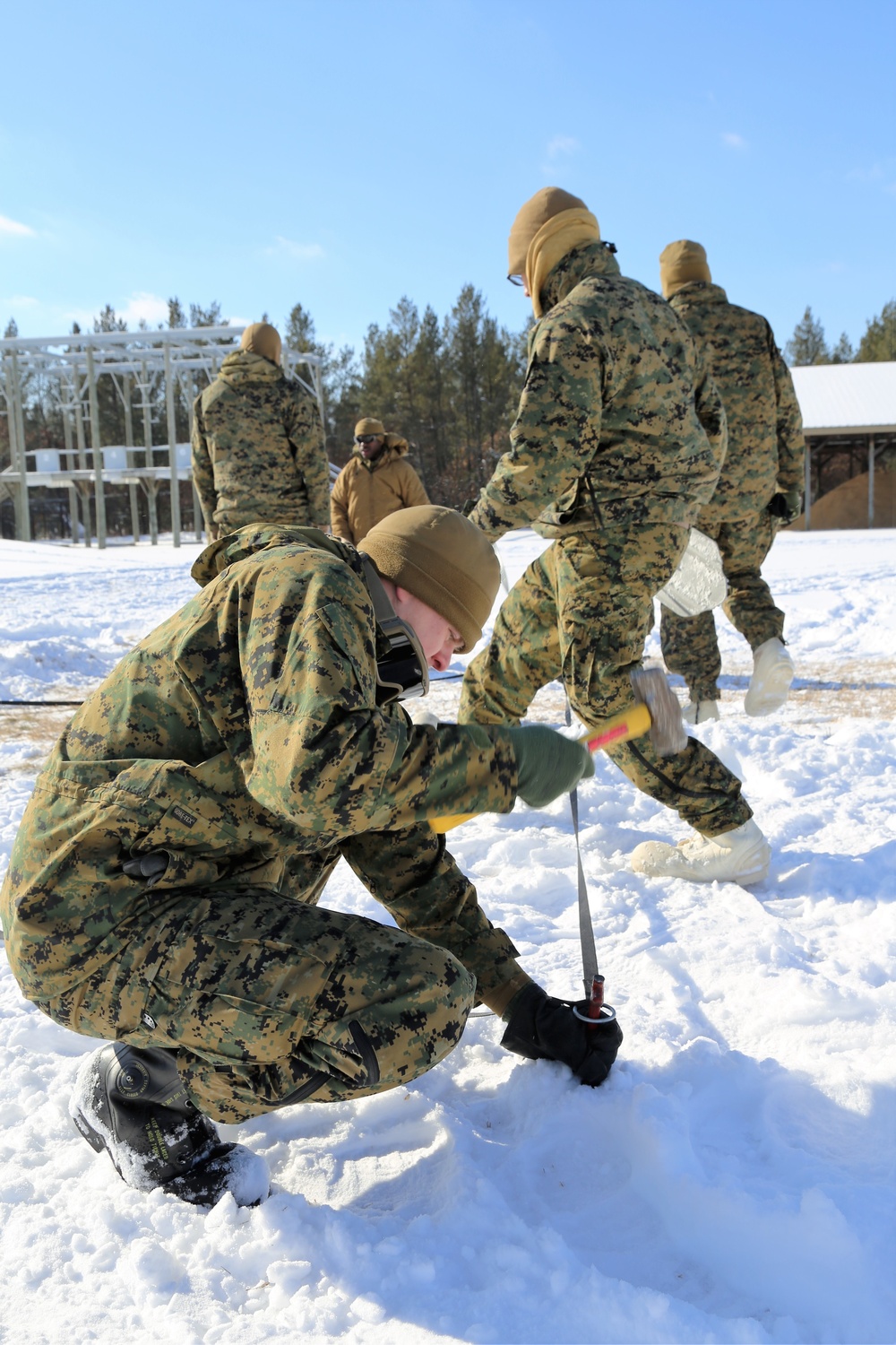 Cold-Weather Operations Course Class 18-04 students build Arctic tents during training at Fort McCoy