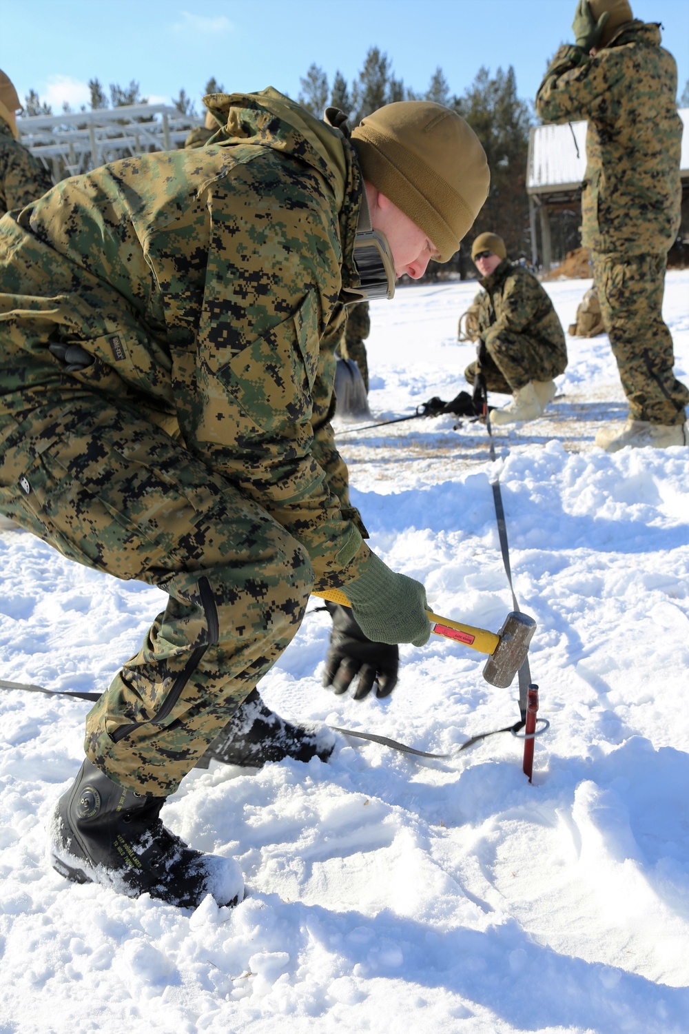 Cold-Weather Operations Course Class 18-04 students build Arctic tents during training at Fort McCoy